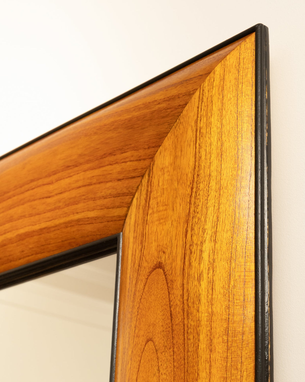 Corner detail of 1950s Italian wooden mirror frame showing wood grain