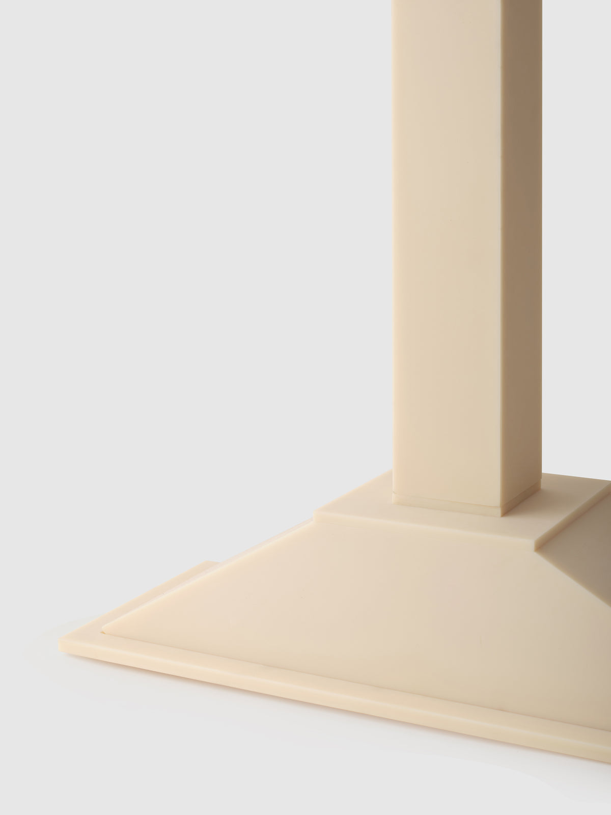 Close-up detail of beige ABS floor lamp base and stem junction