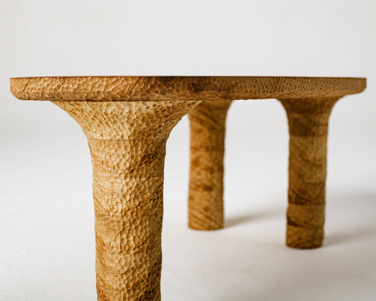 Organic Textured Coffee Table — angled view highlighting handcrafted wooden legs