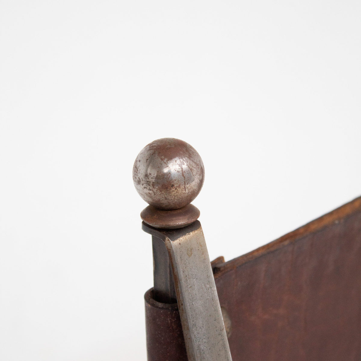 French pair of Iron Curule Chairs in Leather — close-up of metal detail