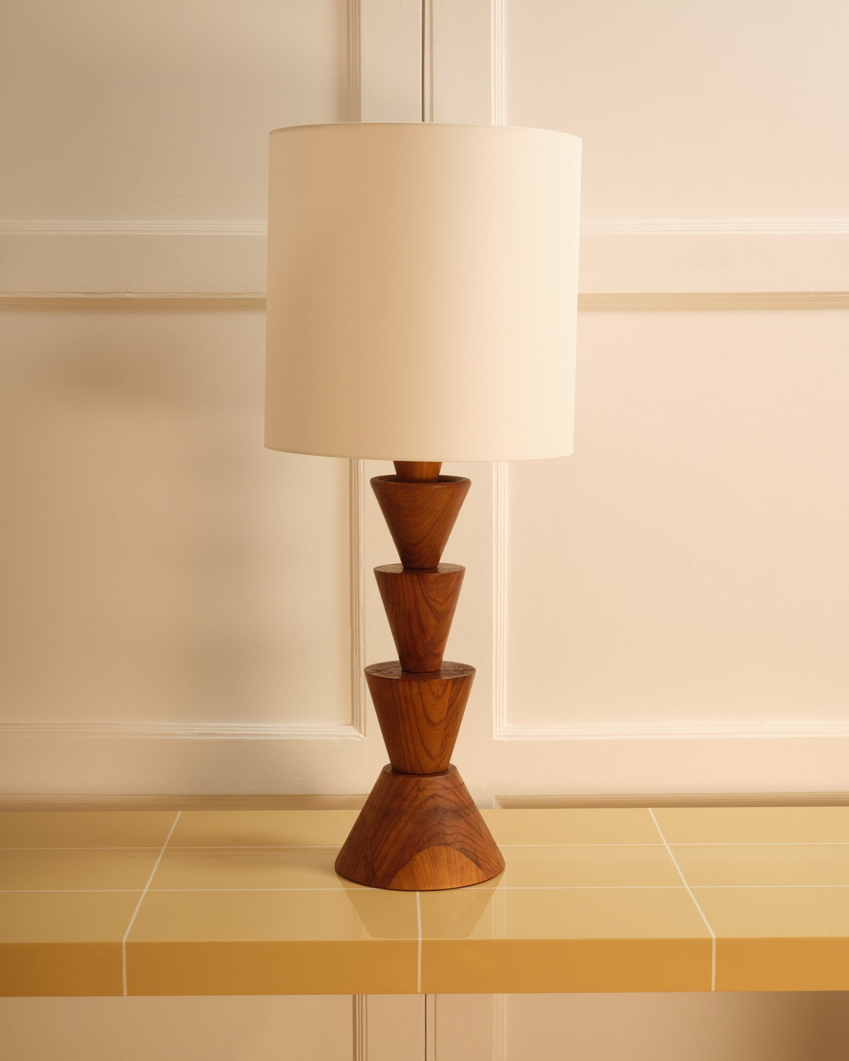 Sculptural wooden table lamp with stacked cone base design