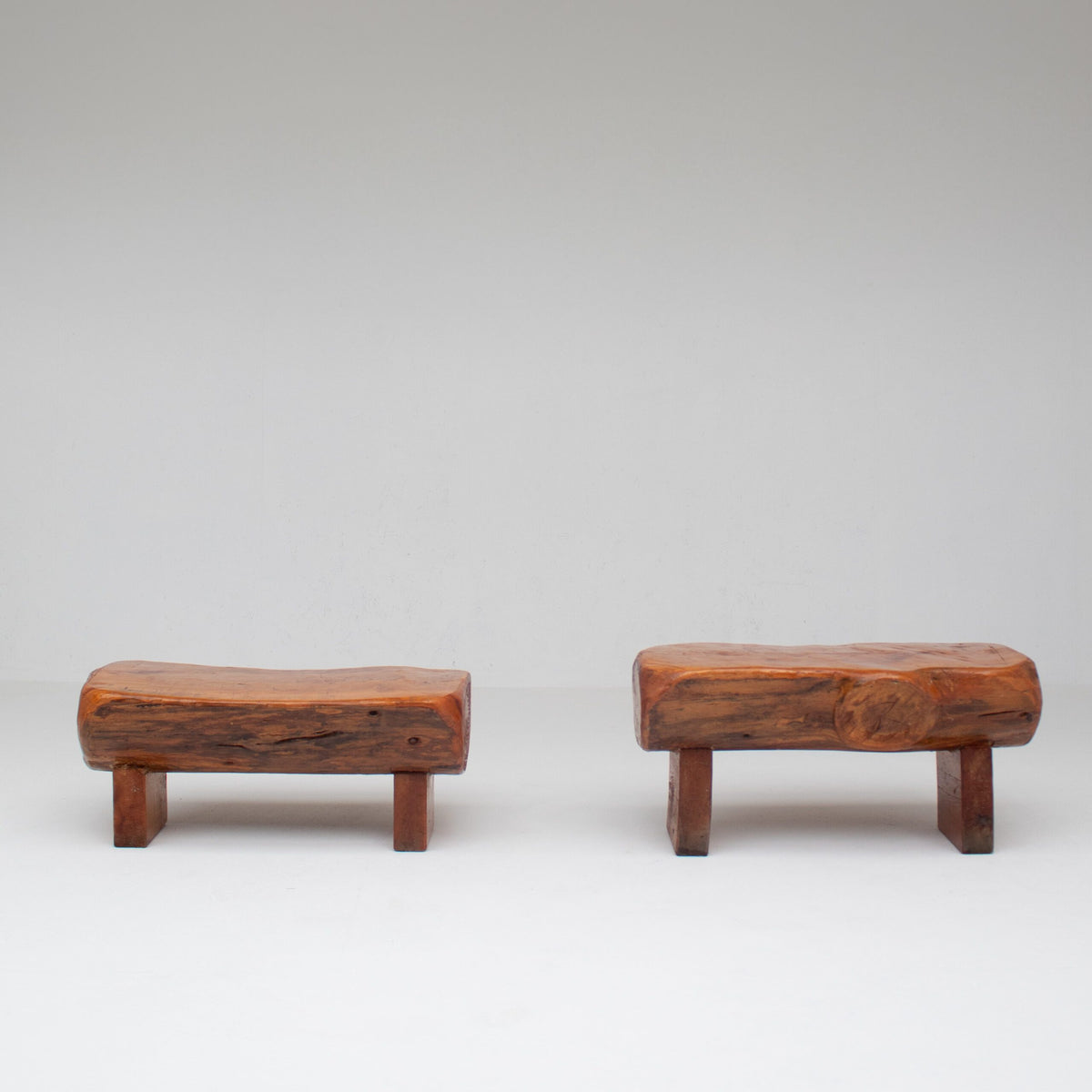 Pair of Rustic Wooden Sculptural Benches in Solid Wood — angled view on white background