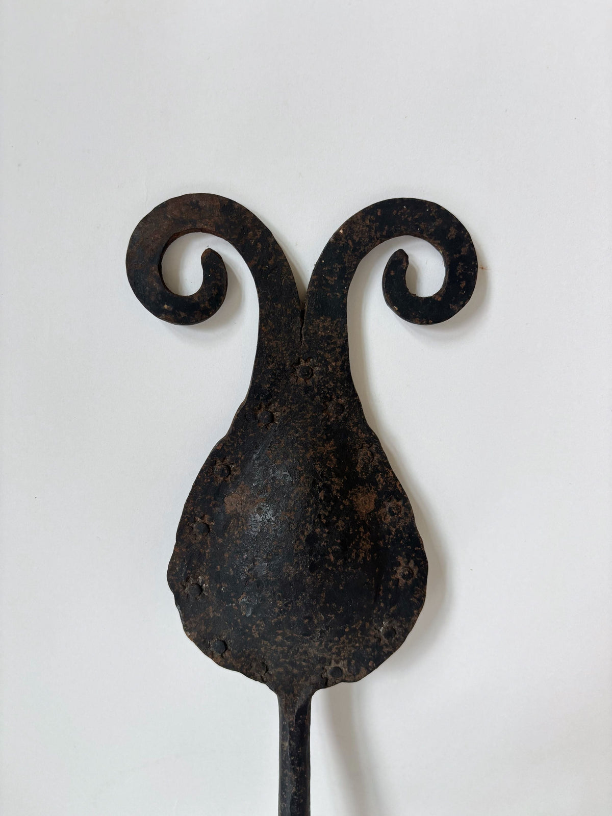 Hand-forged iron candleholder with curved scrollwork arms detail