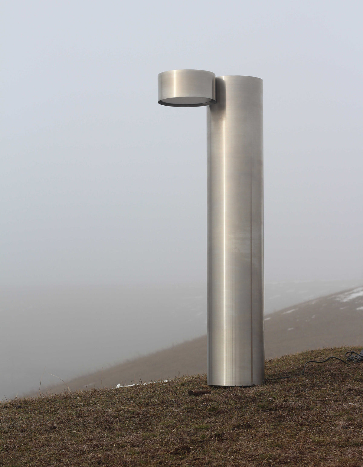 X floor lamp — side view of brushed stainless steel design