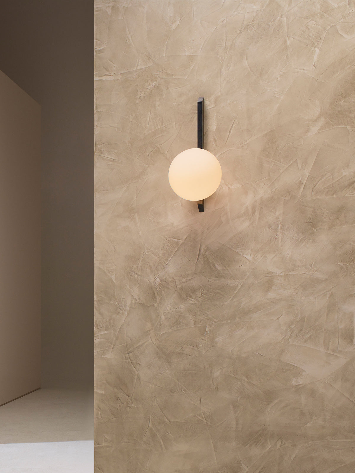 GAIA Wall Tall - Flush — close-up of round glass shade on textured wall