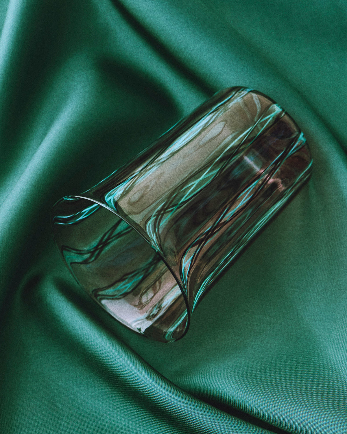 Clara Glasses - Set of four — close-up of textured glass on green fabric