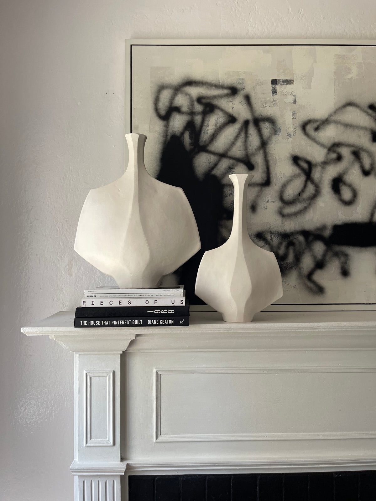 Mid-Century Modern Sculptural Vessel in White Stoneware – Small Hanè — displayed on mantel above books