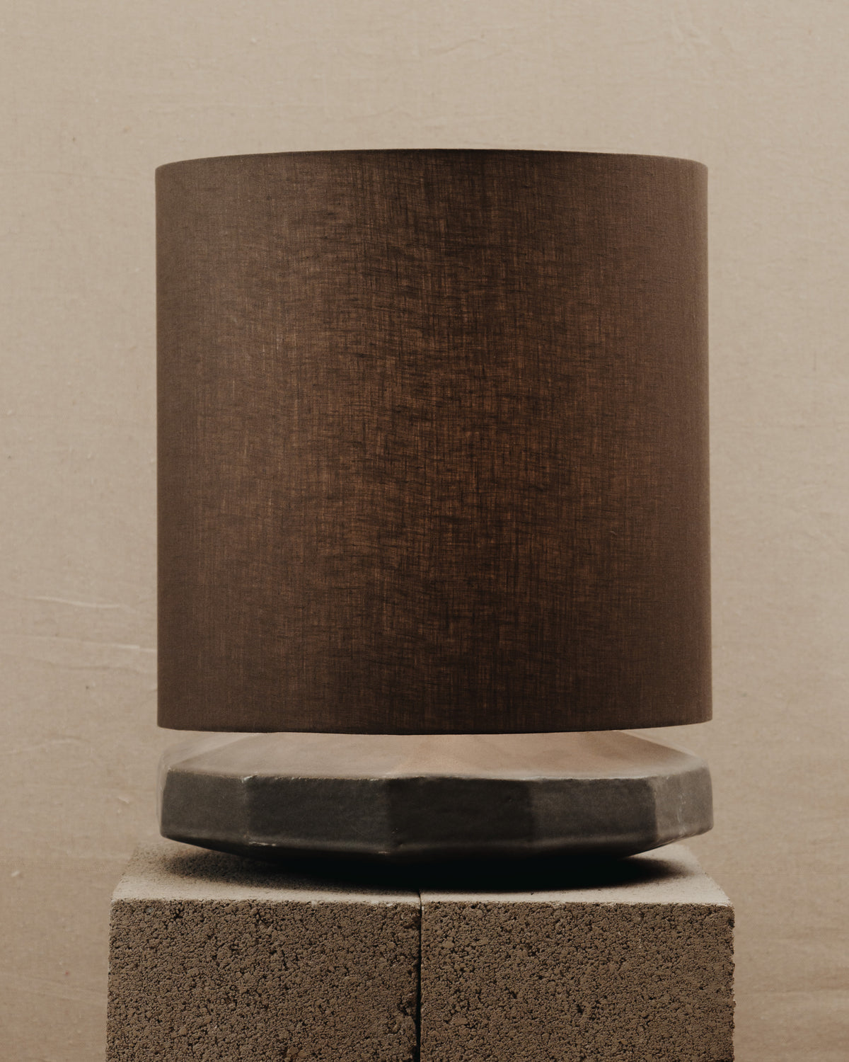 Radian Lamp — side angle showing textured brown shade and concrete base