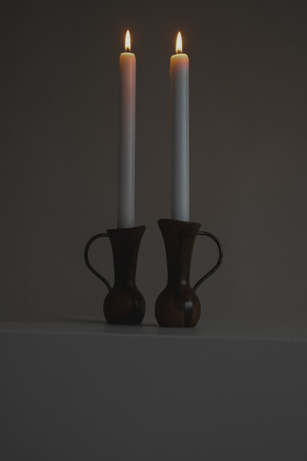Pair of Wooden Candle Holders — side angle with lit white candles
