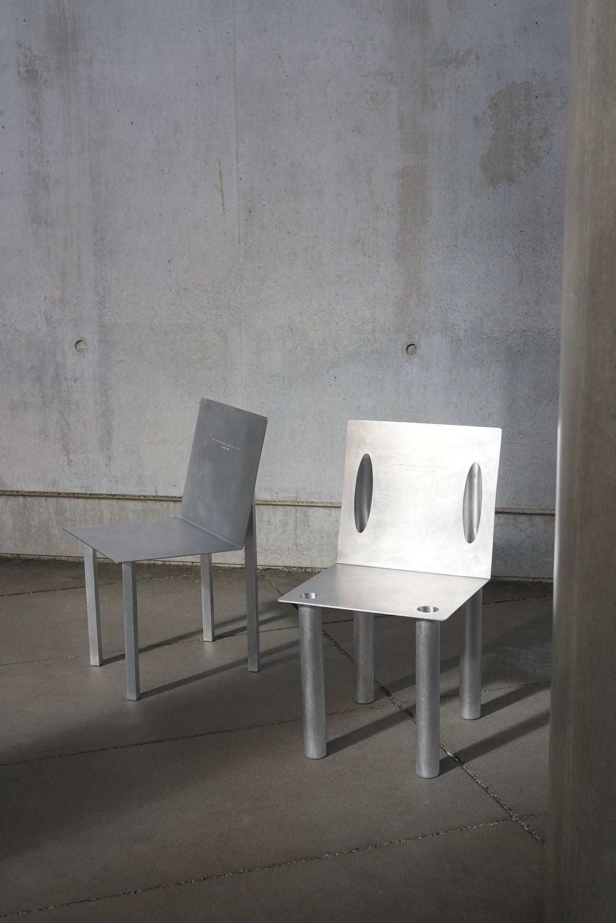 MASTER & MARGARITA — angled view of brushed aluminum chair in minimalist setting