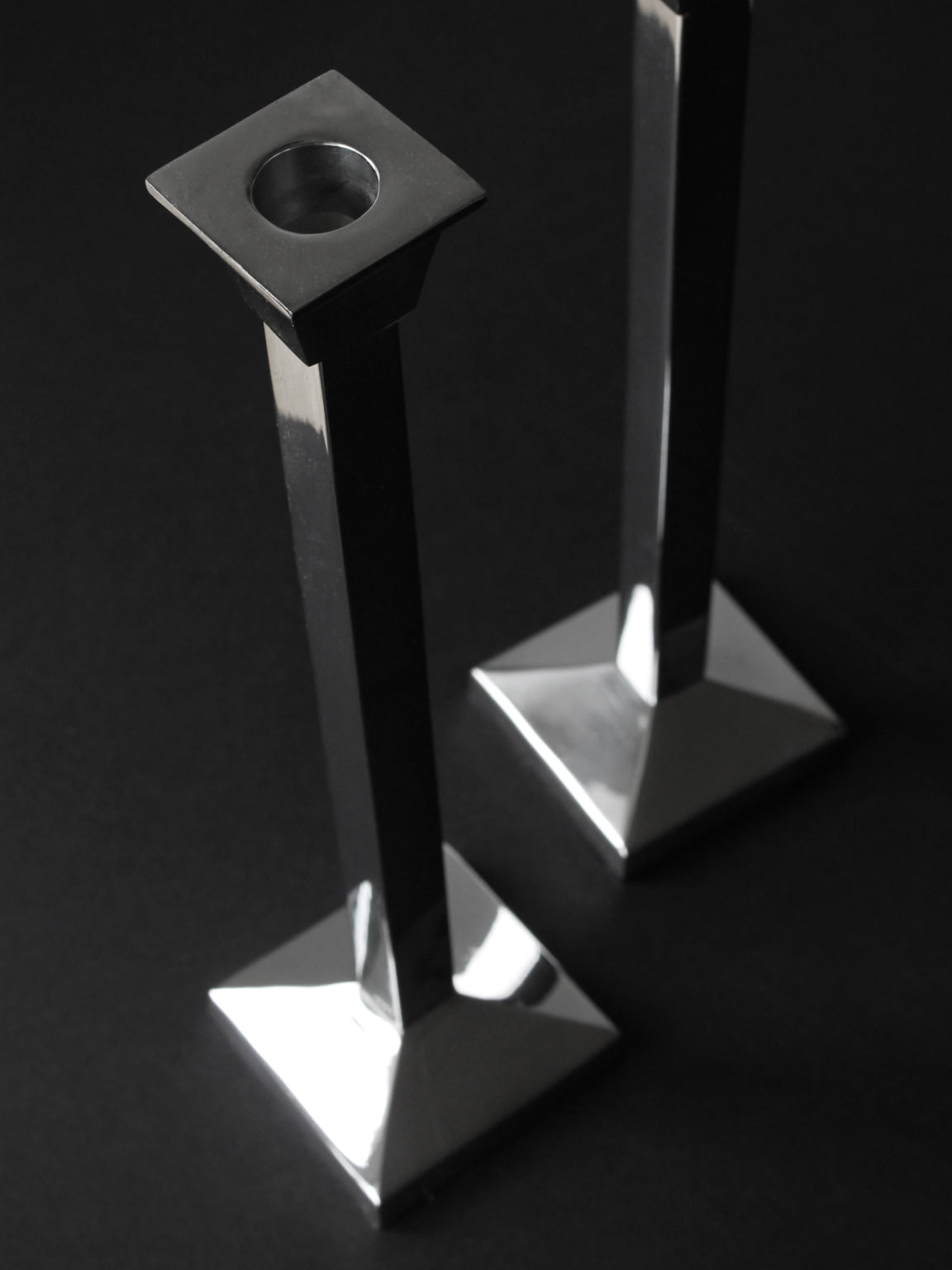 Pair Of Polished Mirror Metal Tall Candle Holders — side angle showing reflective surfaces