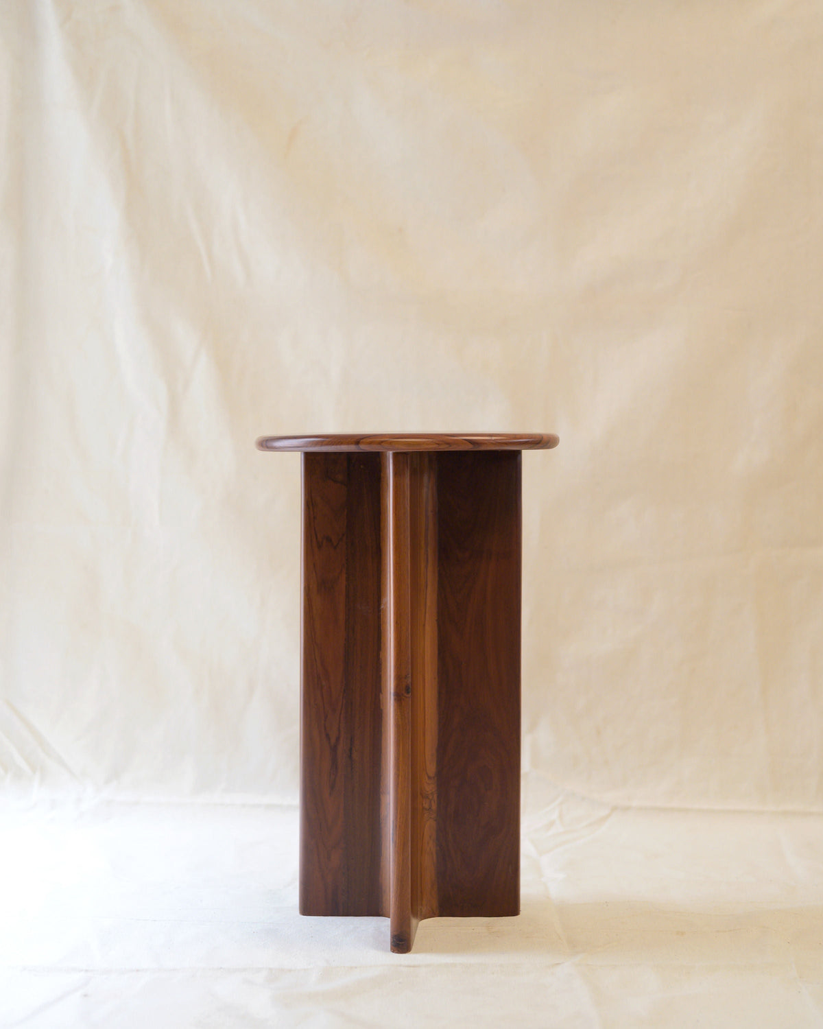 Nemo walnut side table profile view showing cylindrical base design