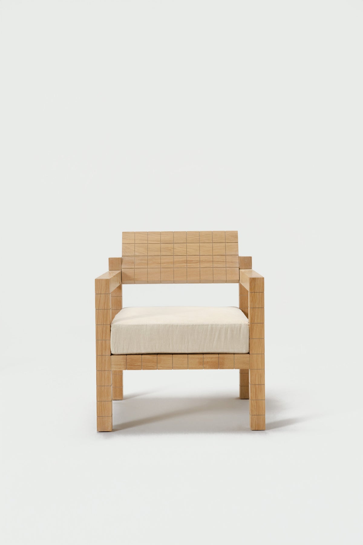 Mosaico Armchair — front view with natural wood finish and cream cushion