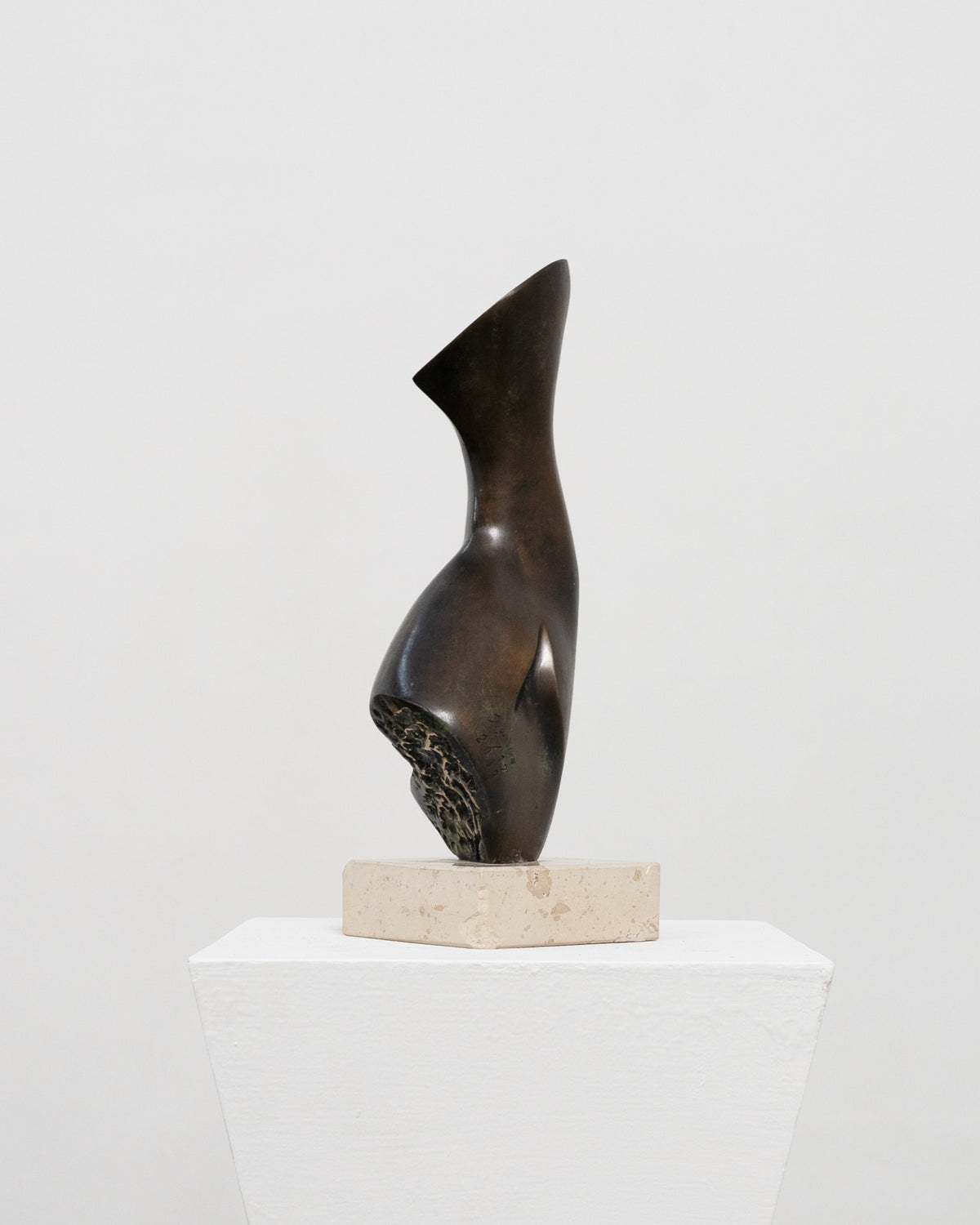 Abstract bronze sculpture with curved form on marble base by Stanislaw Wysocki