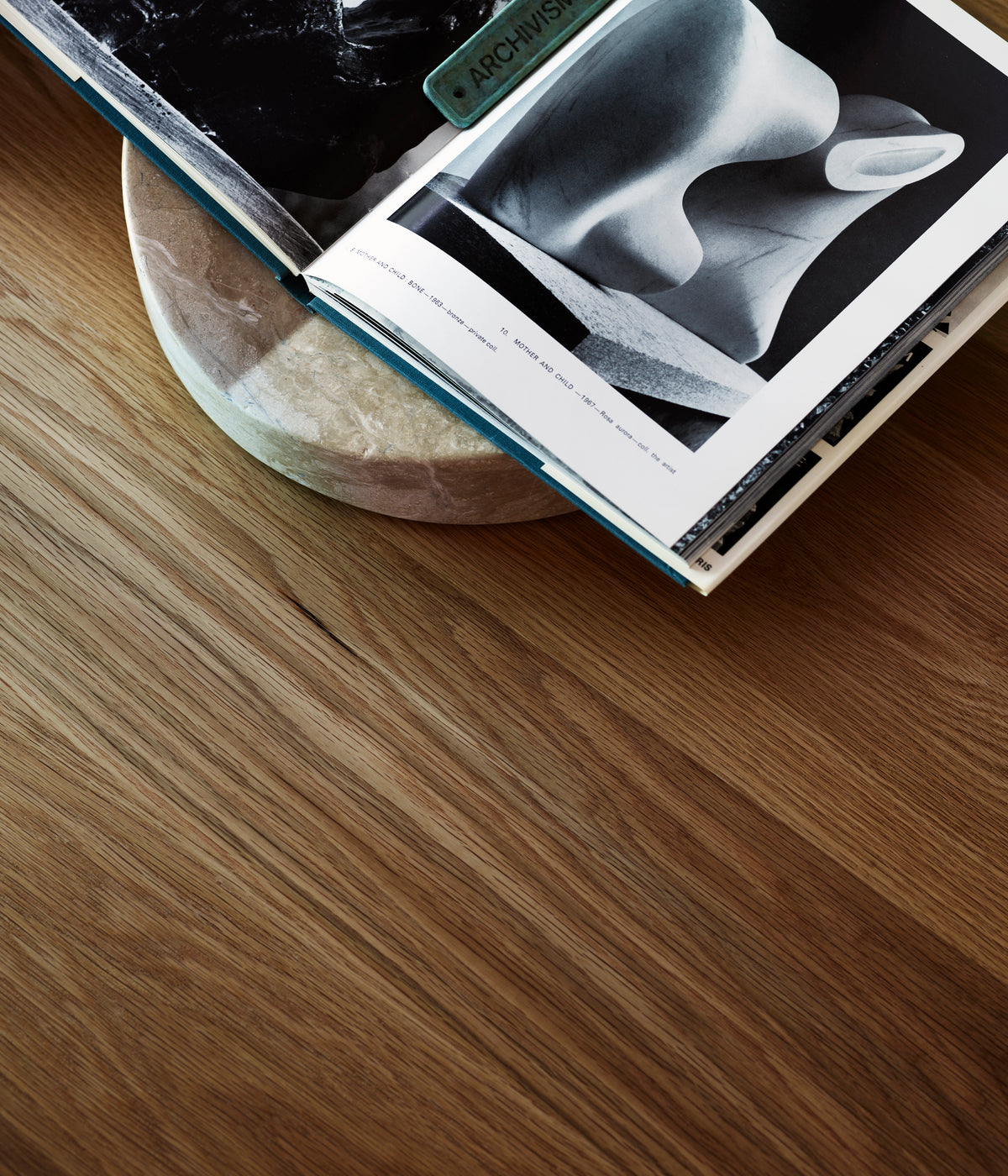 Fane marble bookstand lifestyle view with magazines on wood surface