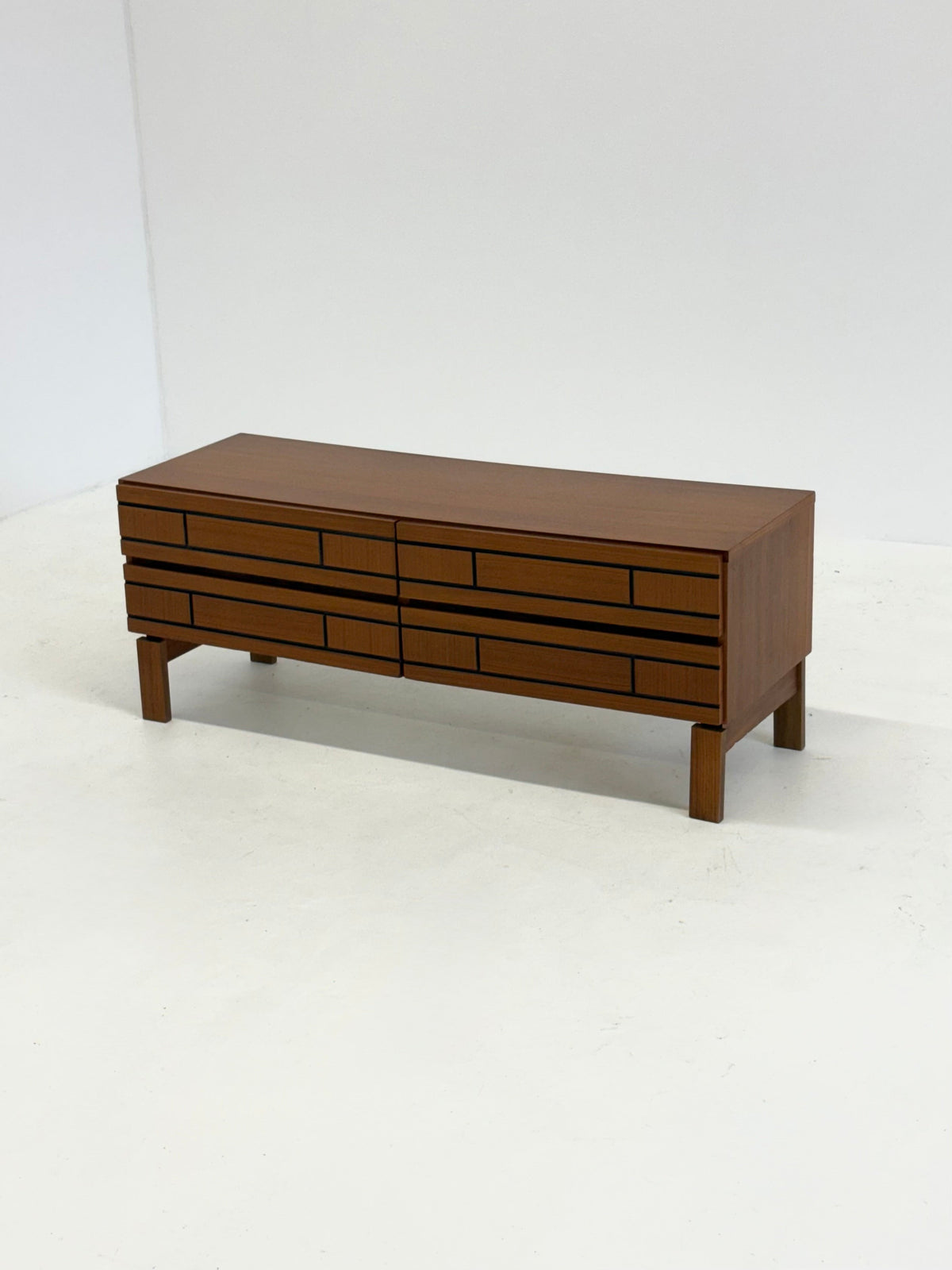 Low Italian wooden sideboard with graphic black lines — side angle