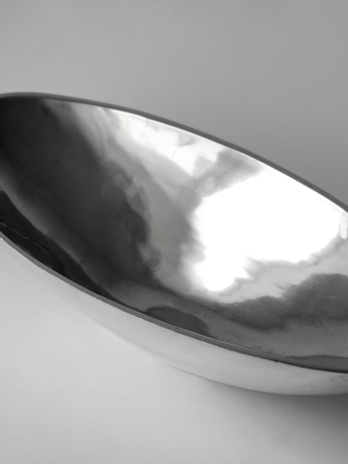 Polished aluminum bowl interior showing reflective curved surface