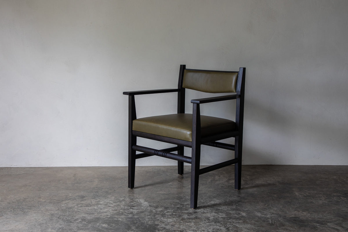 Silo Upholstered Chair — angled view on concrete floor