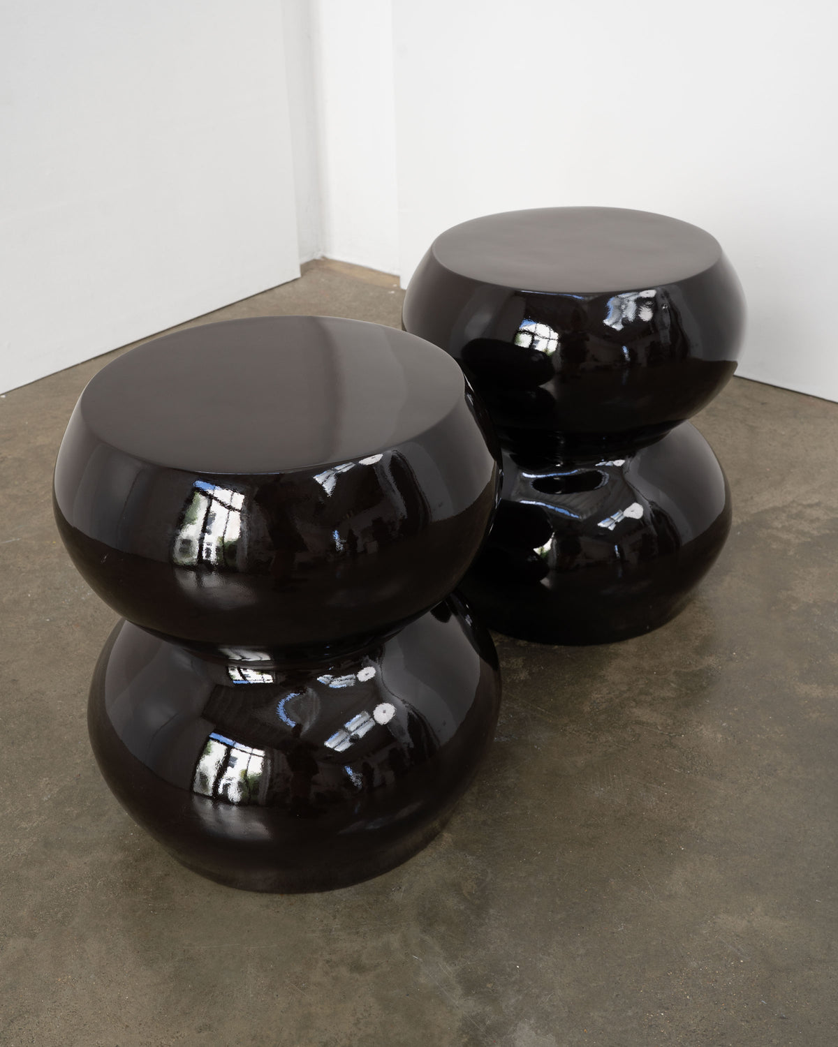 Two black glossy sculptural stools side tables 1970s modern design