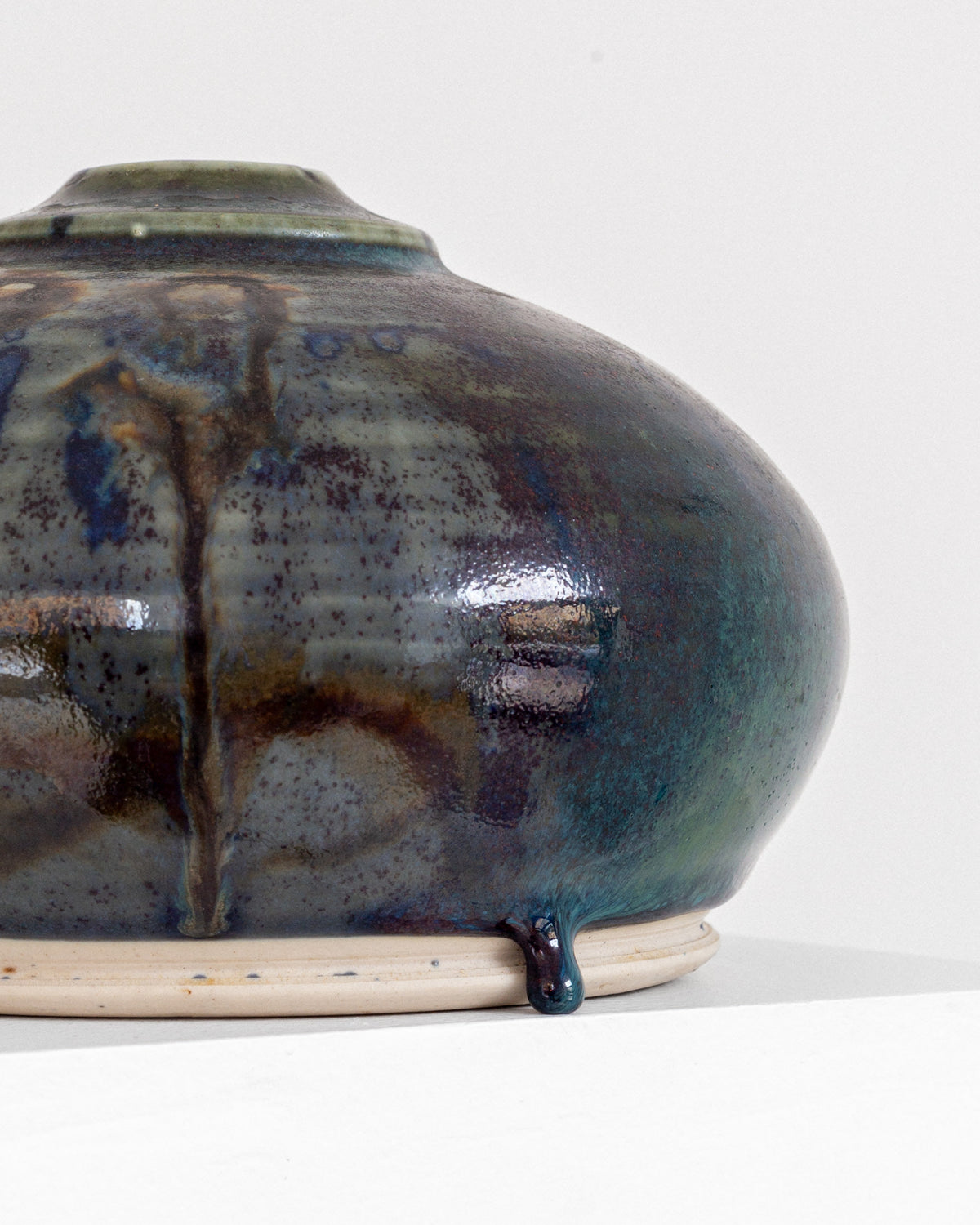 Close-up detail of drip glaze texture on mid-century pottery vase