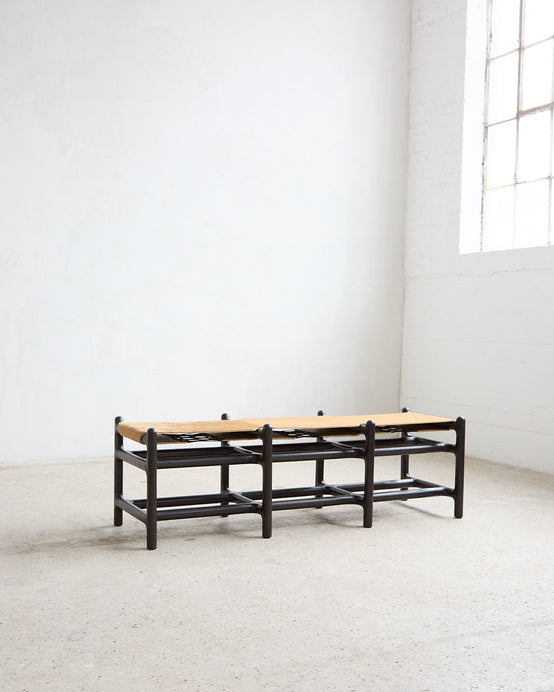 Lyndoe Bench in Solid Wood and Leather — side angle in minimalist room