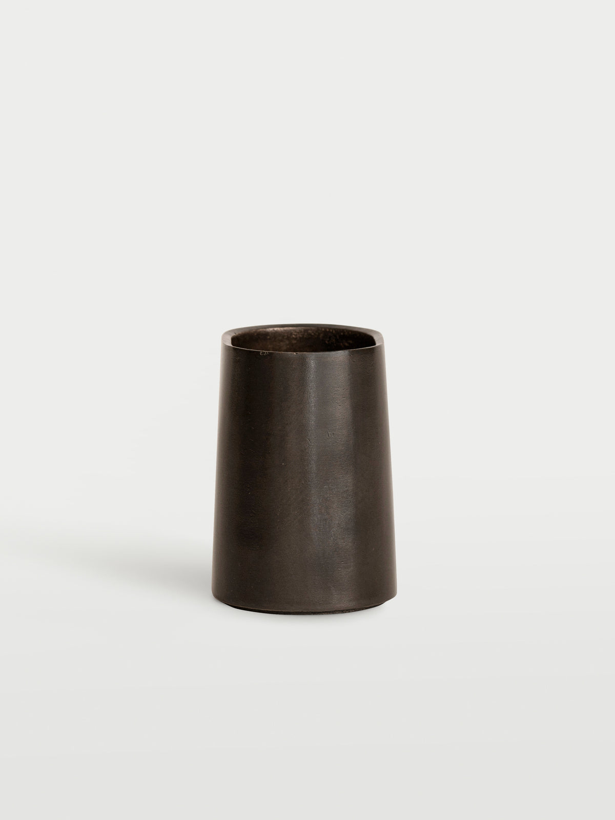 Taper Pen Stand — close-up of dark metal texture