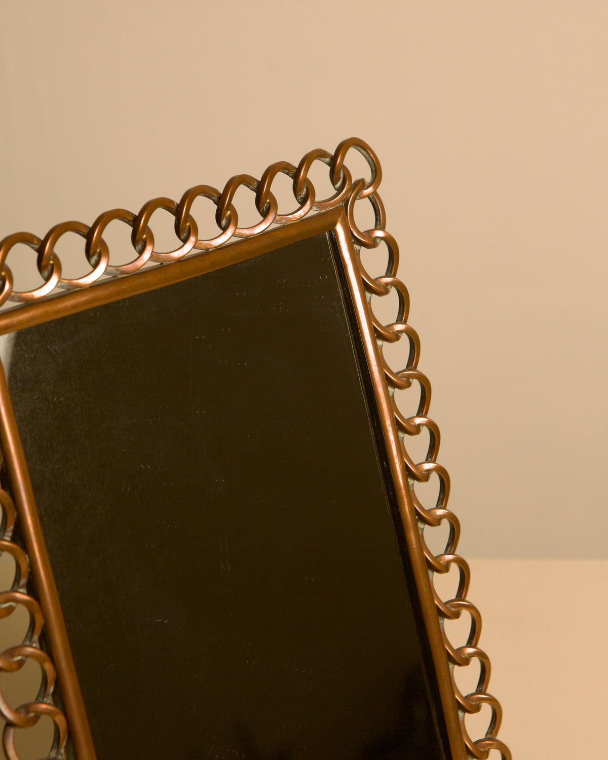 Dutch copper mirror by the Amsterdam School, 1920s — side angle
