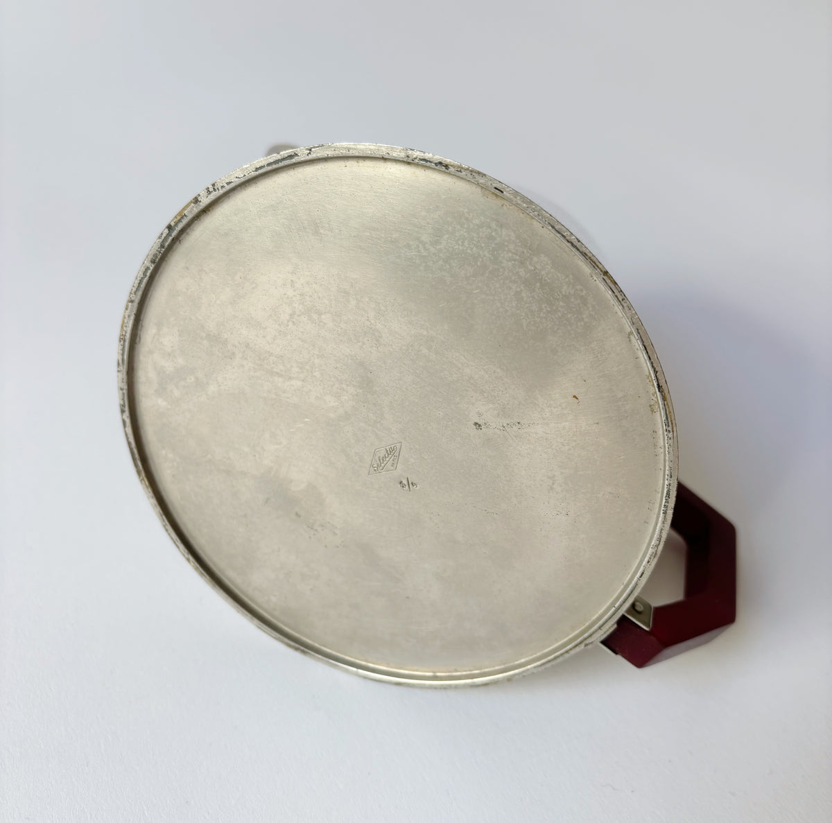 Art Deco Teapot, France — top view of silver surface and red handle