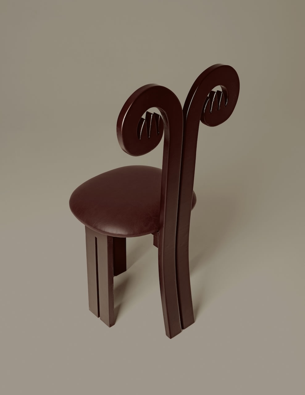 Fiamma burgundy chair with curved spiral backrest detail