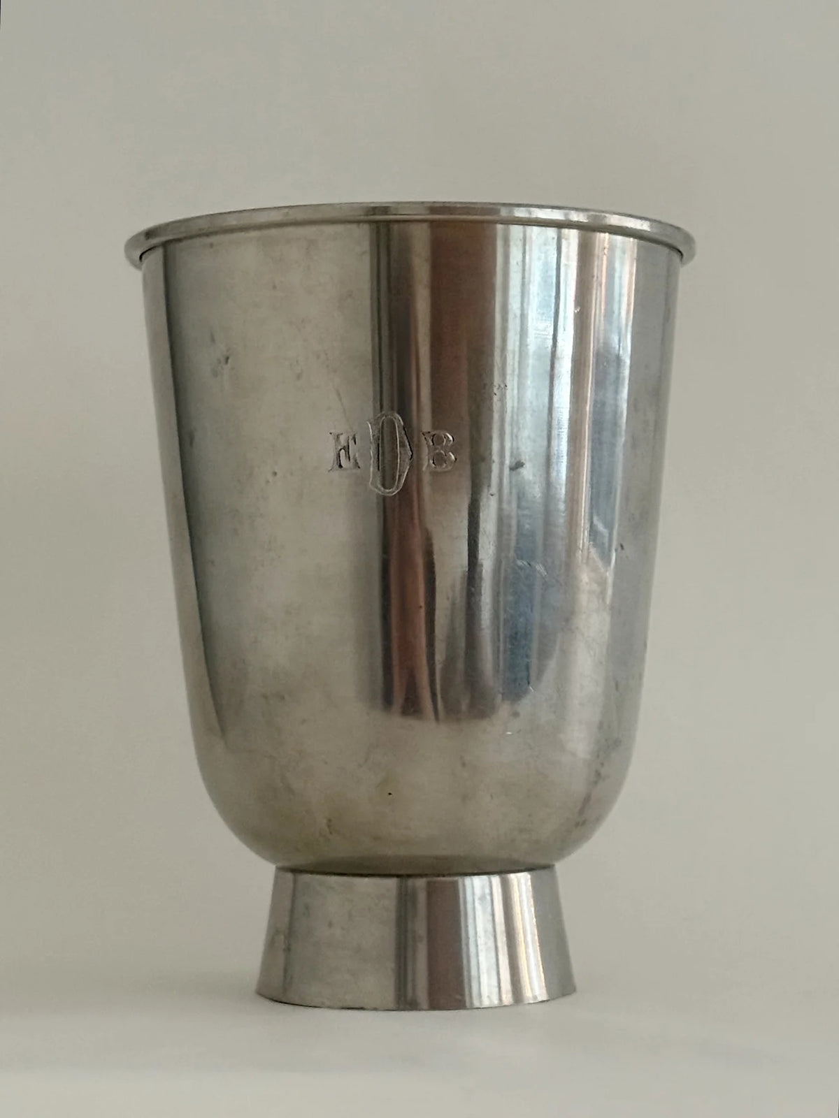 1930s Pewter Vase with Figurative Relief — front view on neutral background