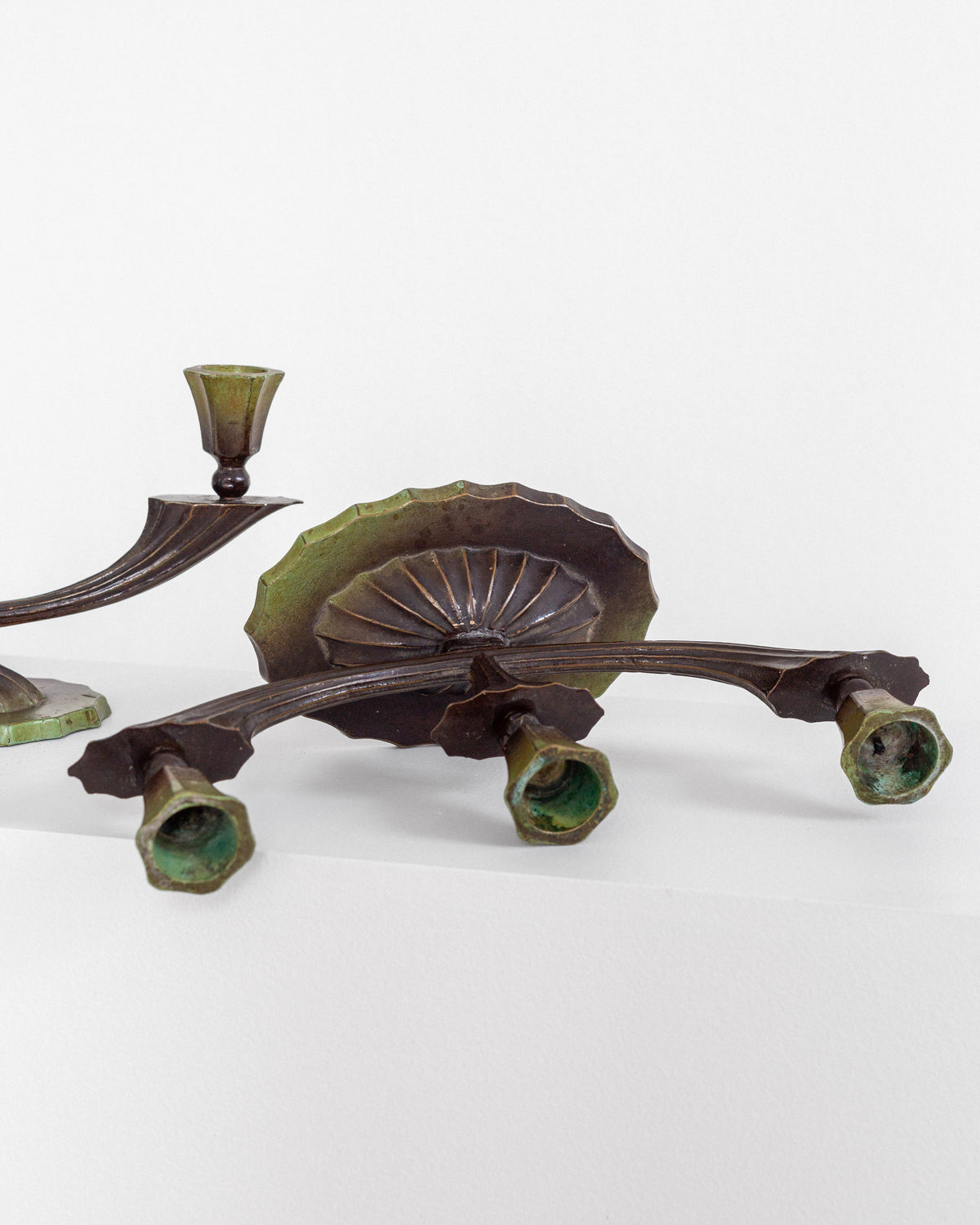 Art Deco bronze candlesticks detail showing patina and feet