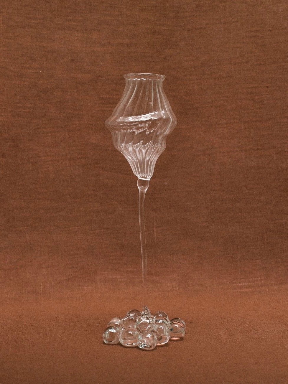 Orphée Liqueur Glasses – Mouth-Blown Set of 2 — close-up of glass texture on brown backdrop
