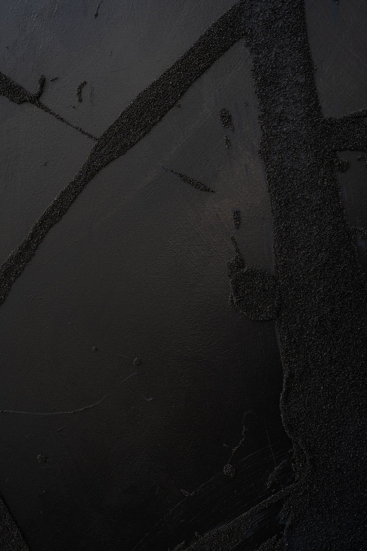 Abstract mixed media canvas showing dark textural brushstrokes