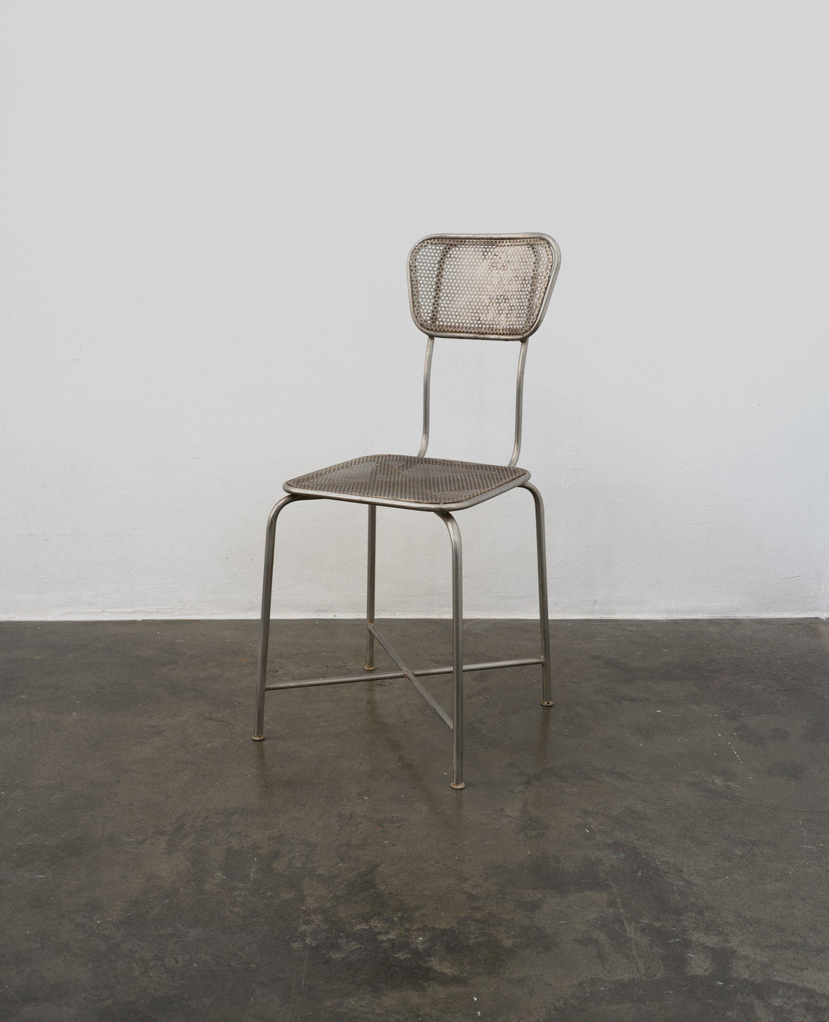 Vintage perforated metal chair with tubular steel frame by Tom Bogle
