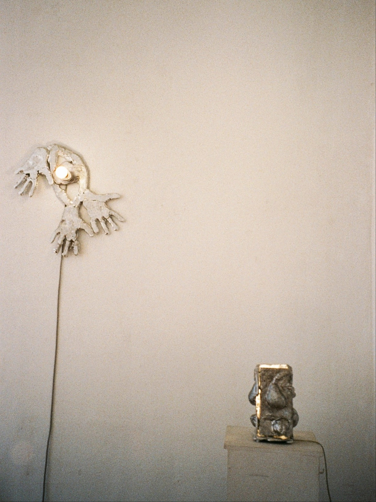 Out Of Shape ceramic wall lamp with hands motif by Ia Kutateladze