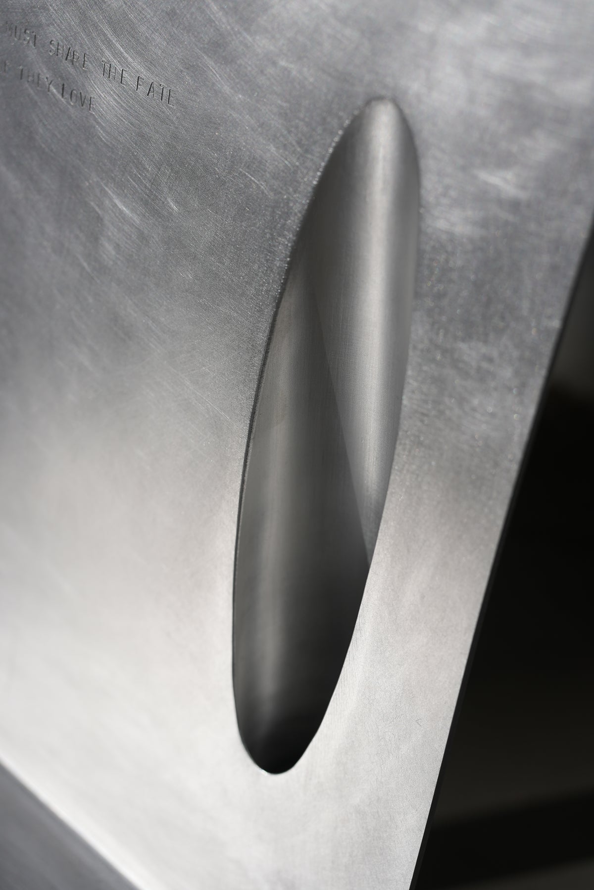MASTER & MARGARITA — close-up of brushed metal surface with cutout
