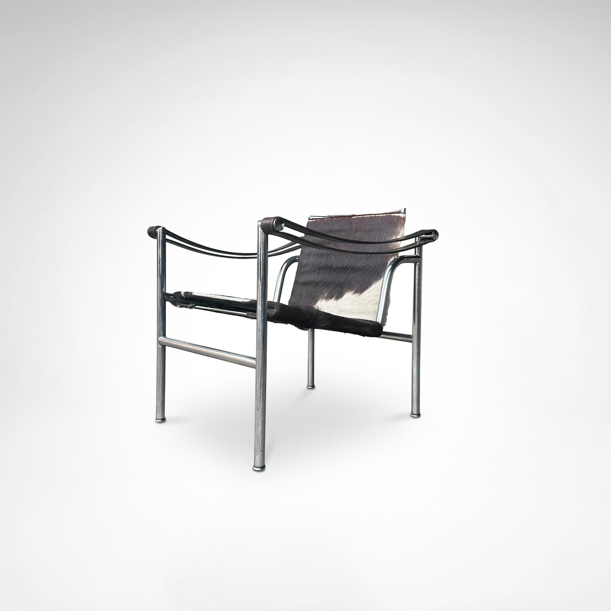 LC1 armchair side view, chrome frame with ponyskin sling