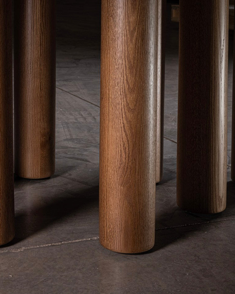 Close-up of solid wood cylindrical legs on 023 dining table