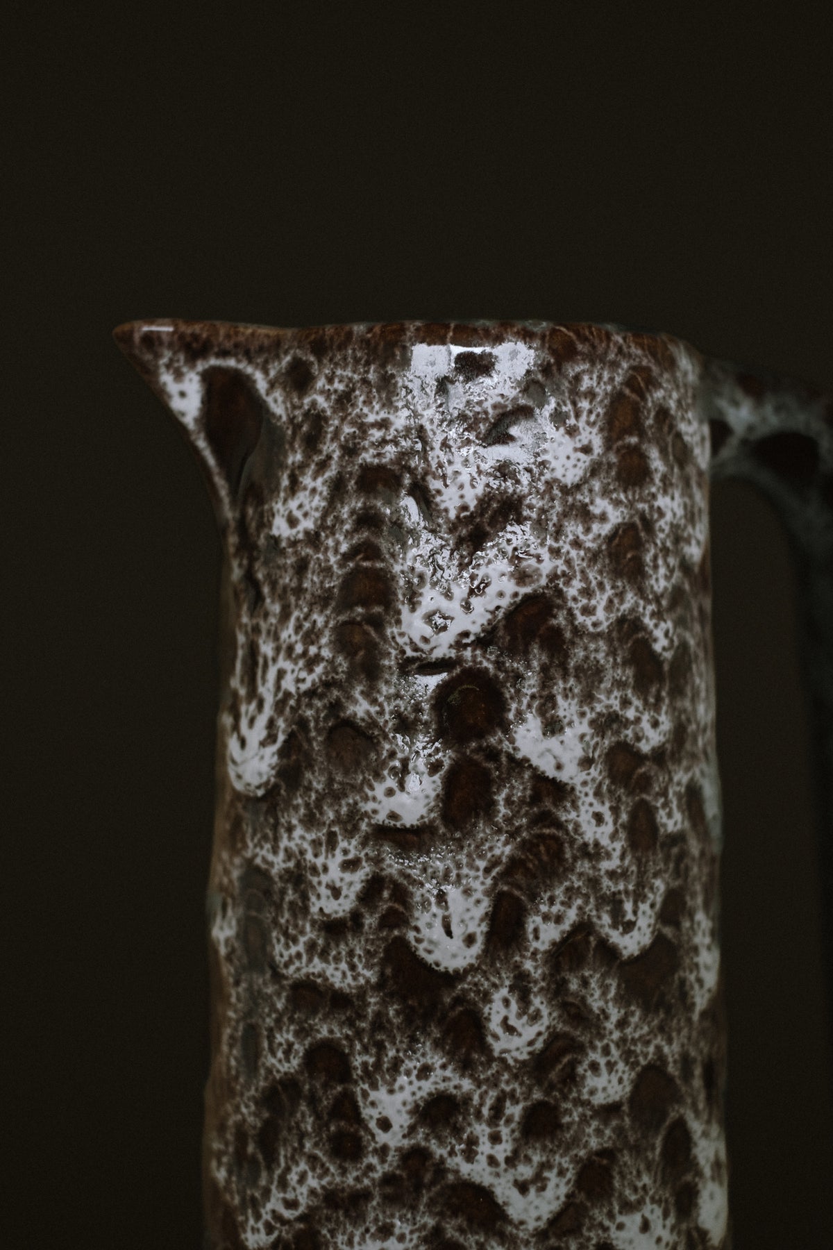 Detailed view of handmade stoneware pitcher with speckled glaze