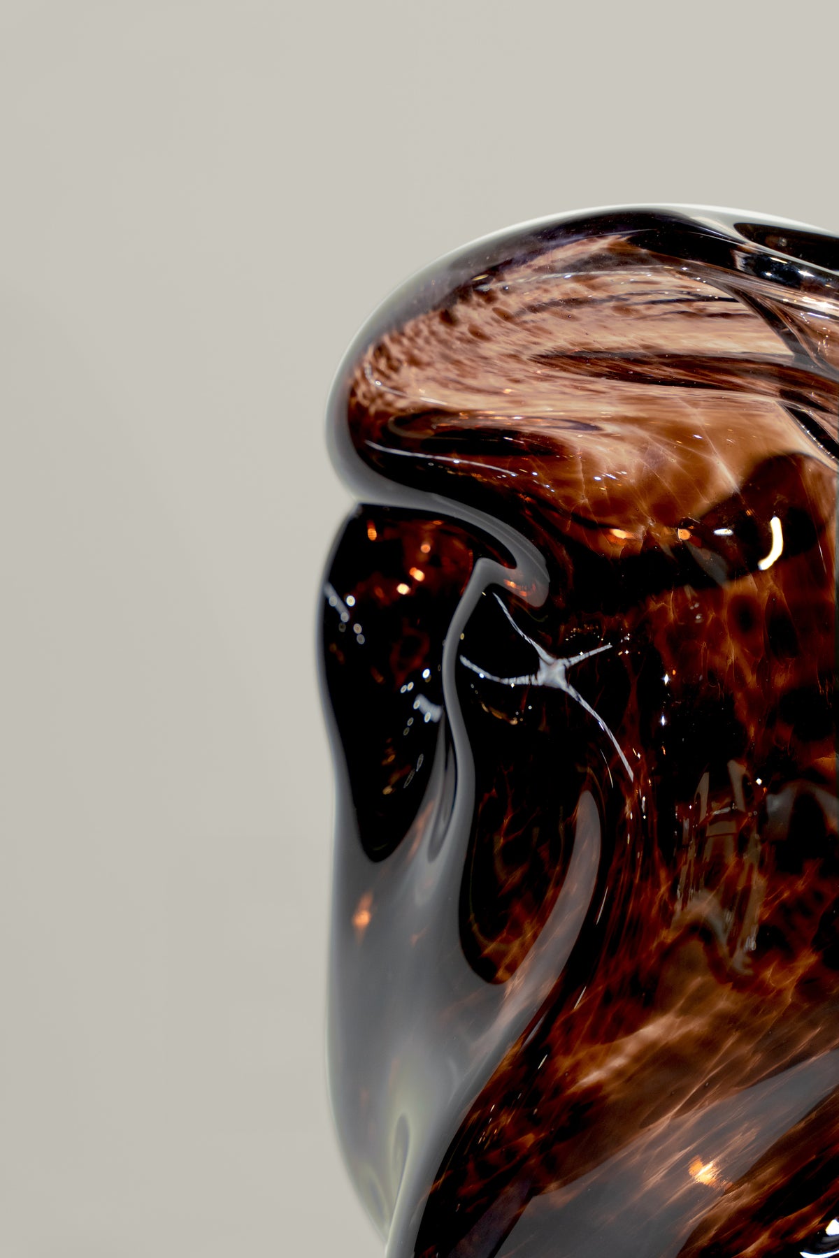 Wave Stool / Side Table I — side angle showing glossy amber glass finish