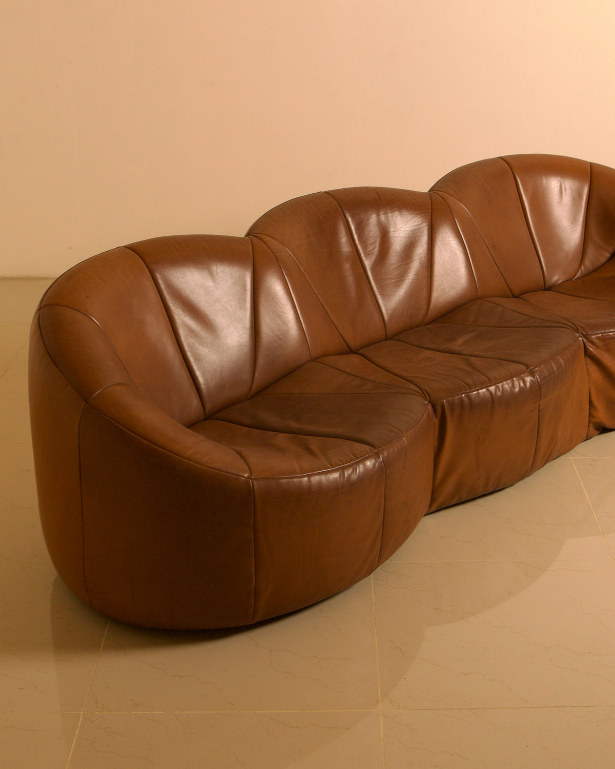 Three-seater "Pumpkin" Sofa by Pierre Paulin for Artifort, 1980 — angled view highlighting brown leather upholstery