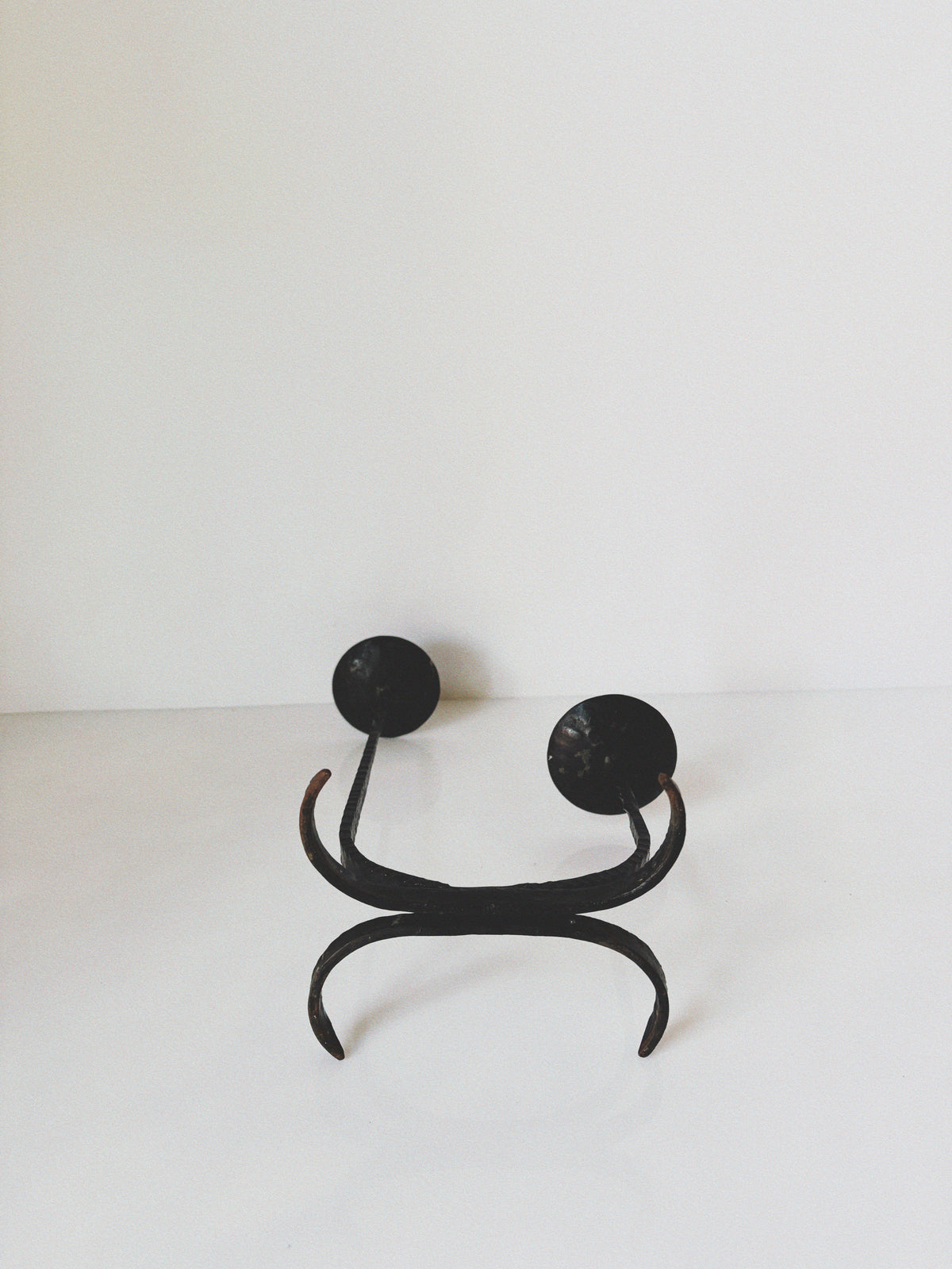 Forged Metal 2 Arm Candlestick, Poland — front view on white background
