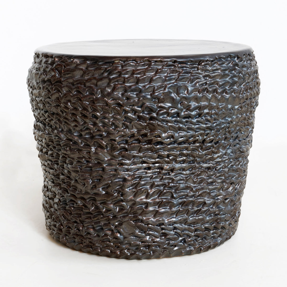 Casa Ceramic Side Table — side view highlighting textured dark ceramic surface