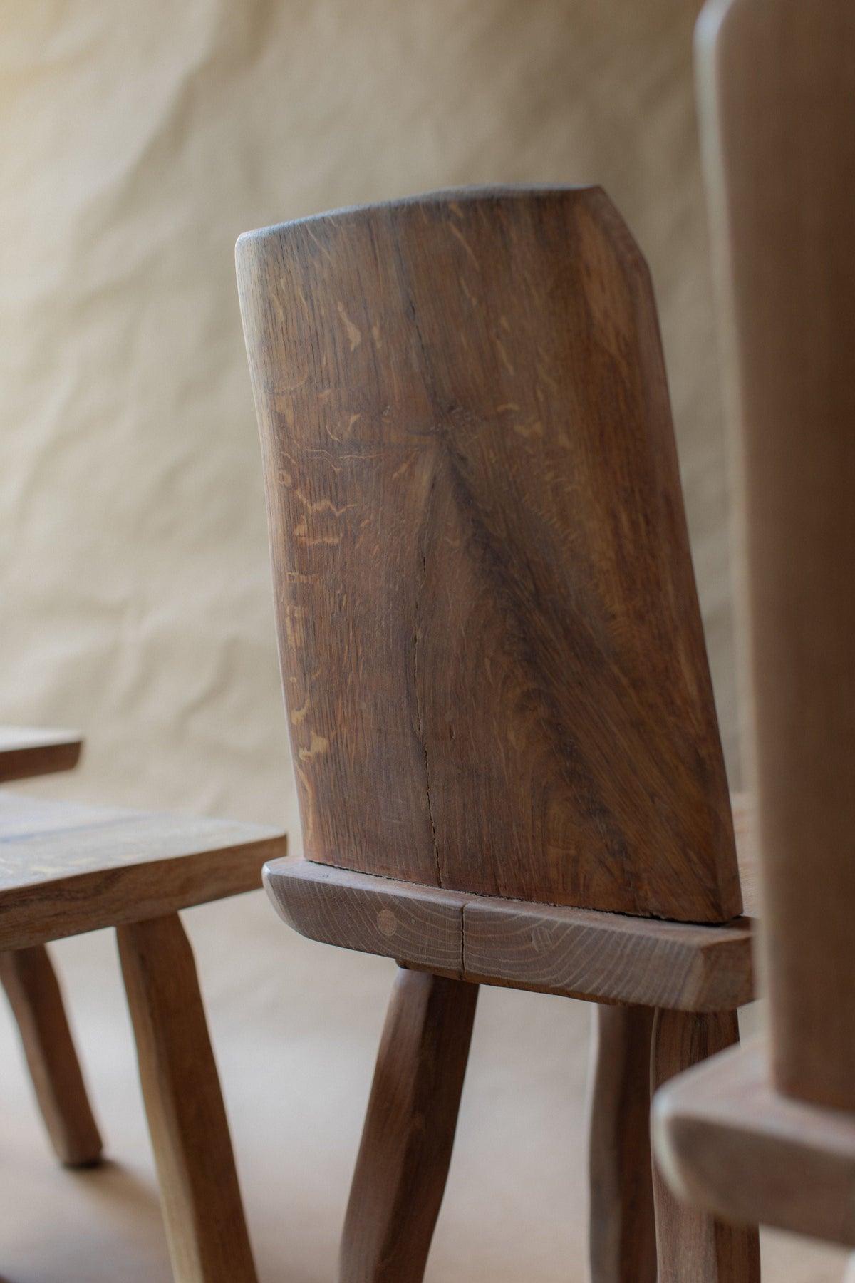 Close-up of brutalist chair backrest showing rich wood grain detail