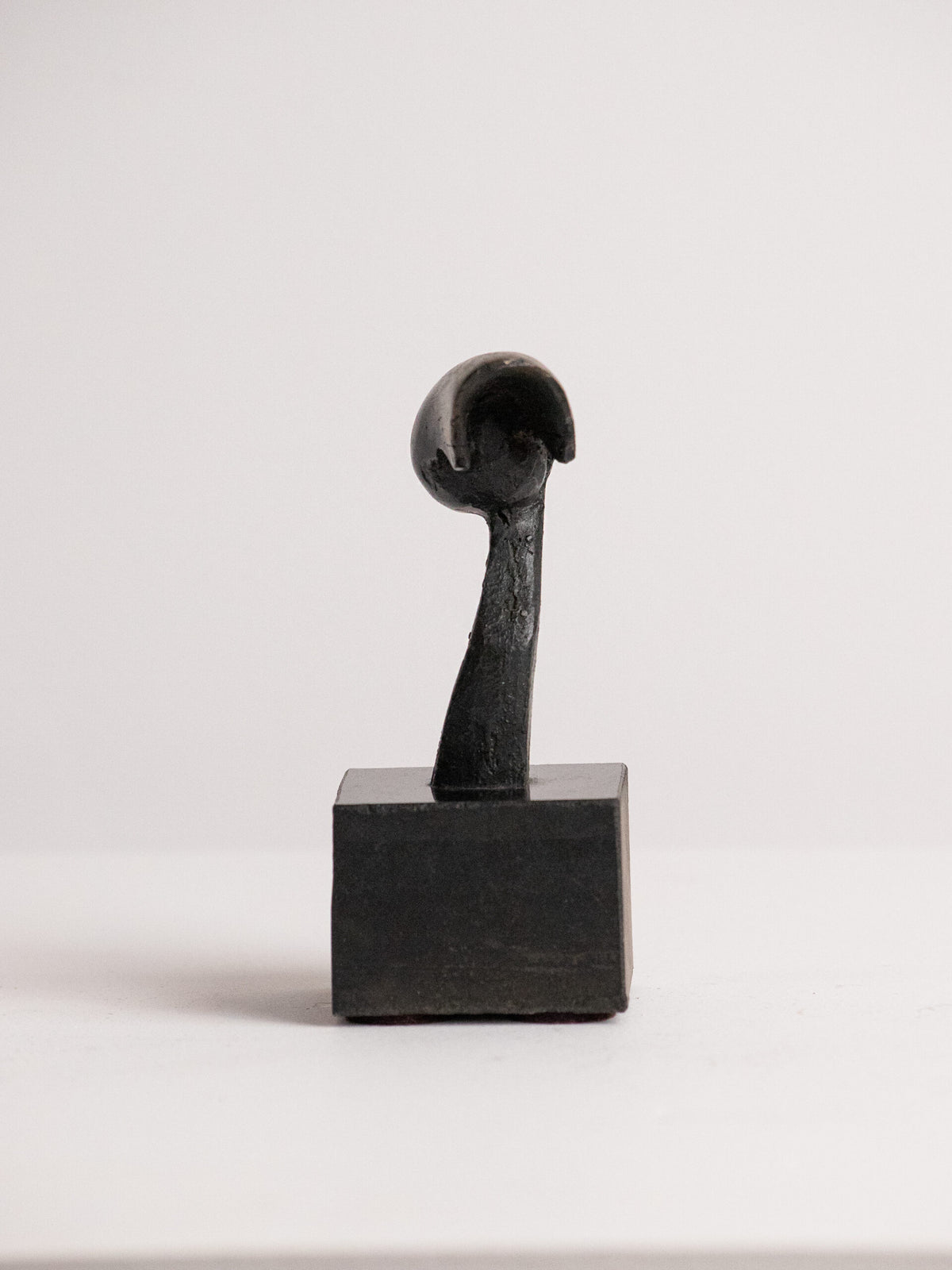 Biomorphic Sculpture in Patinated Metal on a Black Stone Cube, Scandinavian, Late 20th Century — side angle