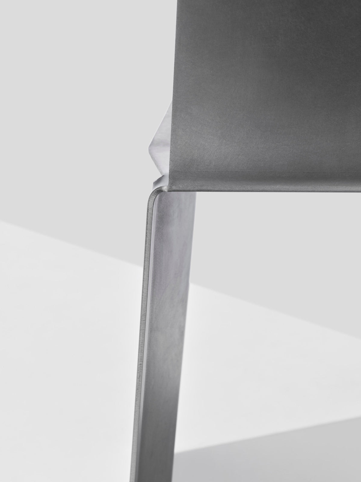 Side profile detail of Camber chair showing curved backrest