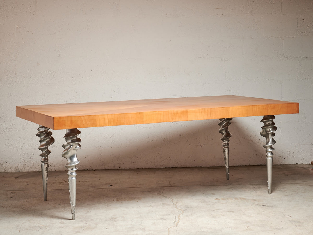 Post-Modern Table with Marquetry Top and Cast Aluminum Legs, 1980's — angled view highlighting wood surface and twisted metal