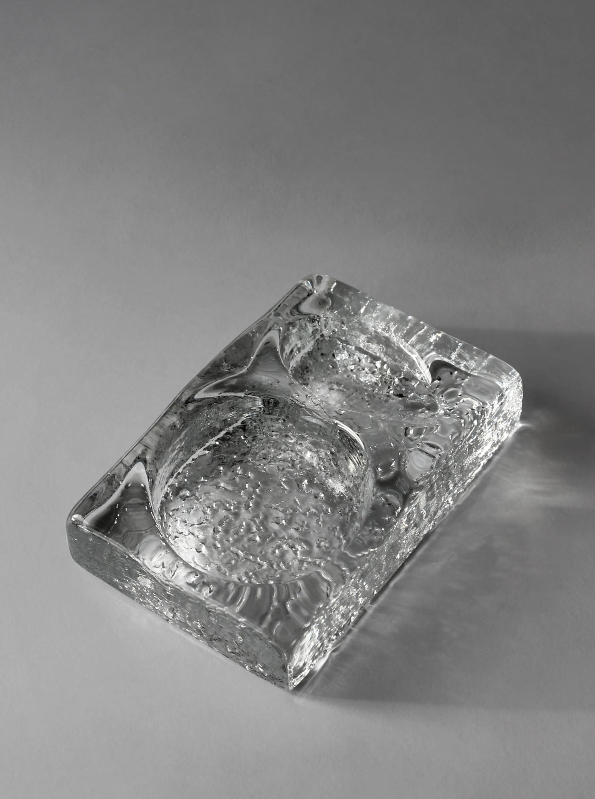 Kosta Boda glass ashtray showing textured interior detail