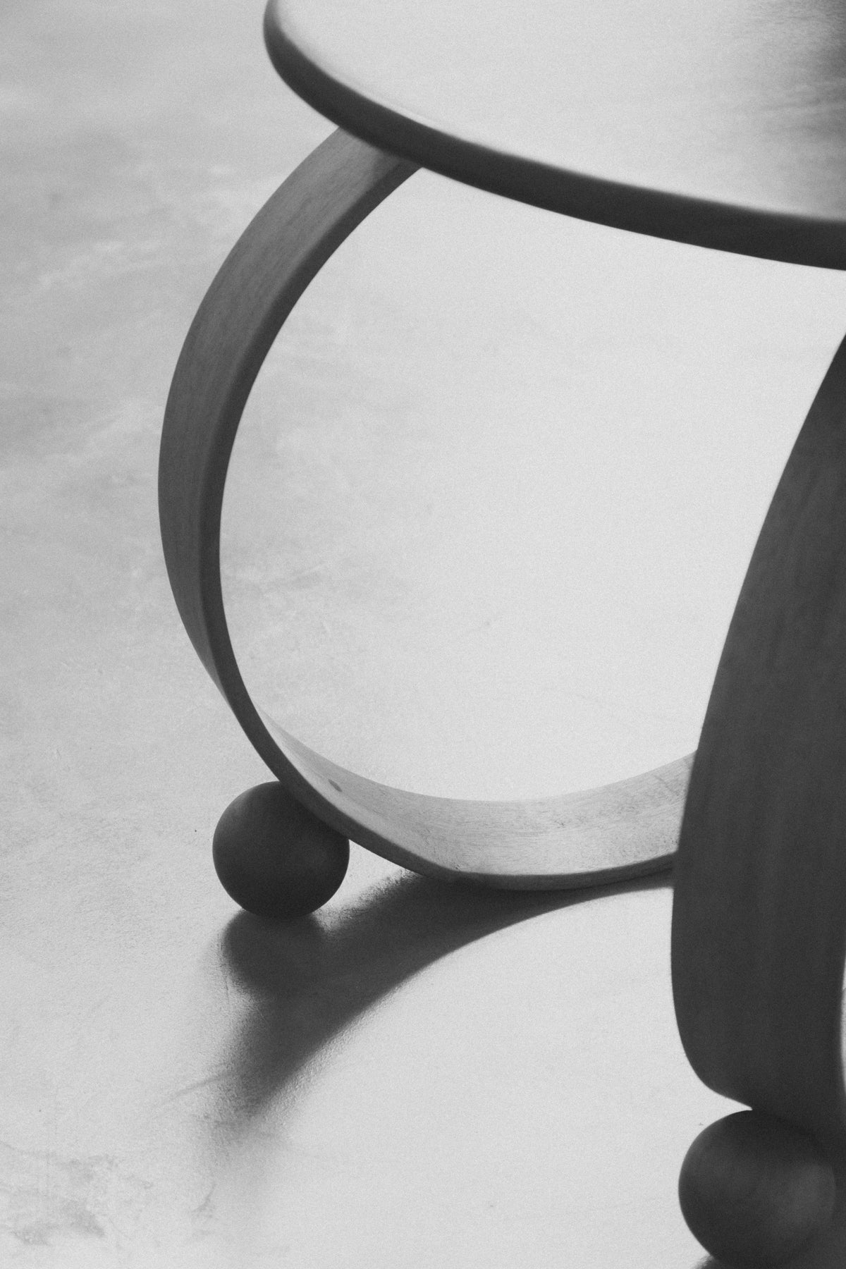 Yara' Chair — back view highlighting curved wooden legs