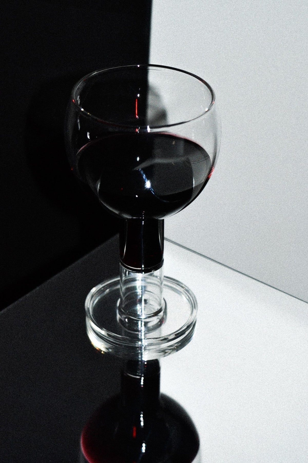 Set of 2 Wine Candle Glasses - Clear — angled view on reflective surface